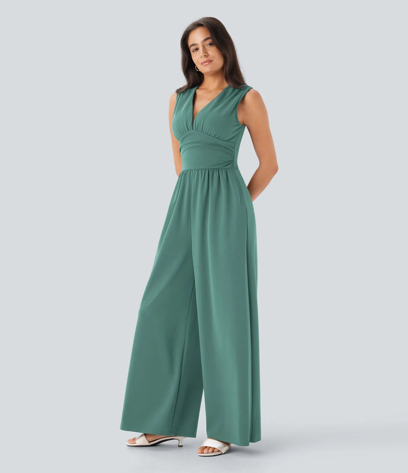 Sleeveless, ruched party jumpsuit with a flattering V-neckline, practical side pockets, and a discreet invisible zipper – stylish and totally bathroom-friendly