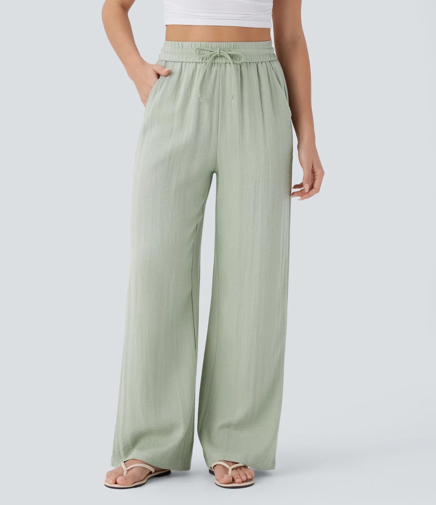 Casual pants with a linen-like feel, high waist, side drawstring, and wide-leg cut.