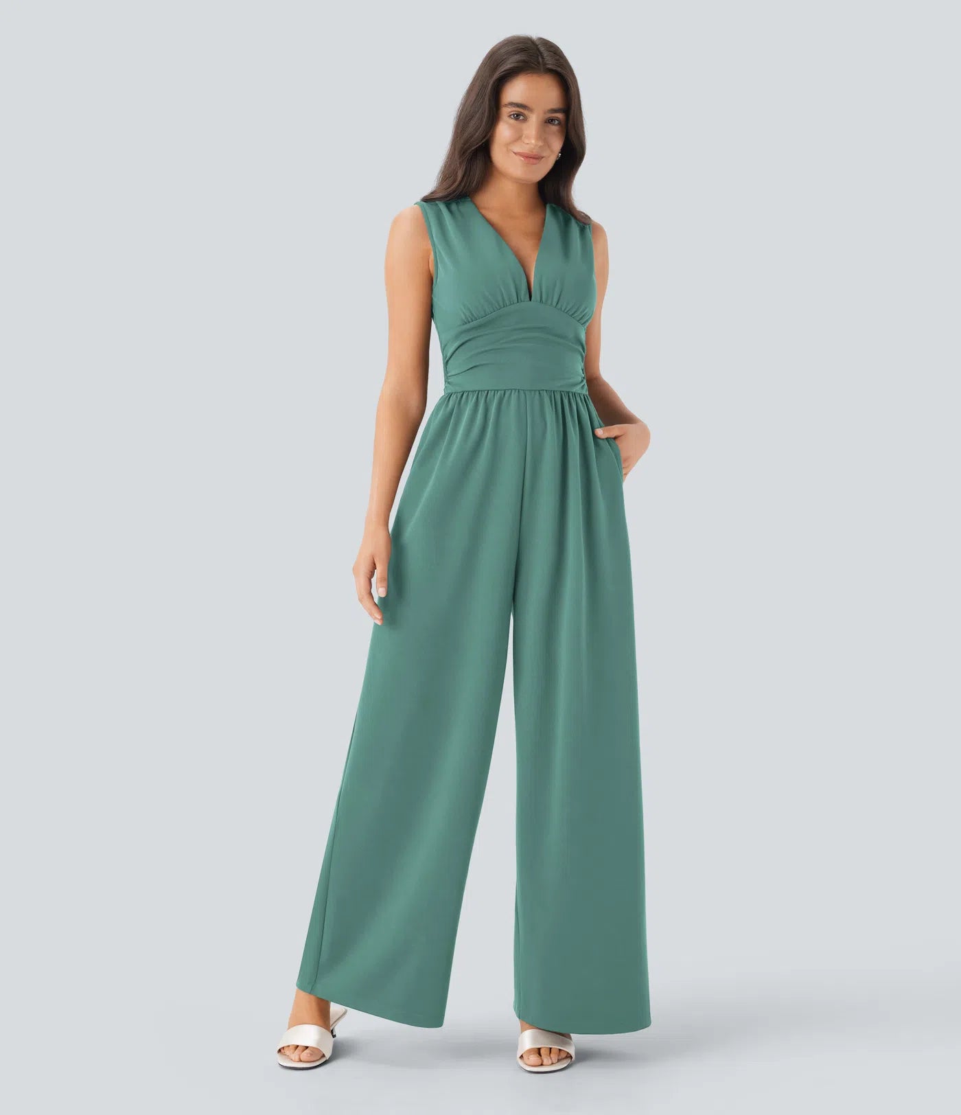 Sleeveless, ruched party jumpsuit with a flattering V-neckline, practical side pockets, and a discreet invisible zipper – stylish and totally bathroom-friendly