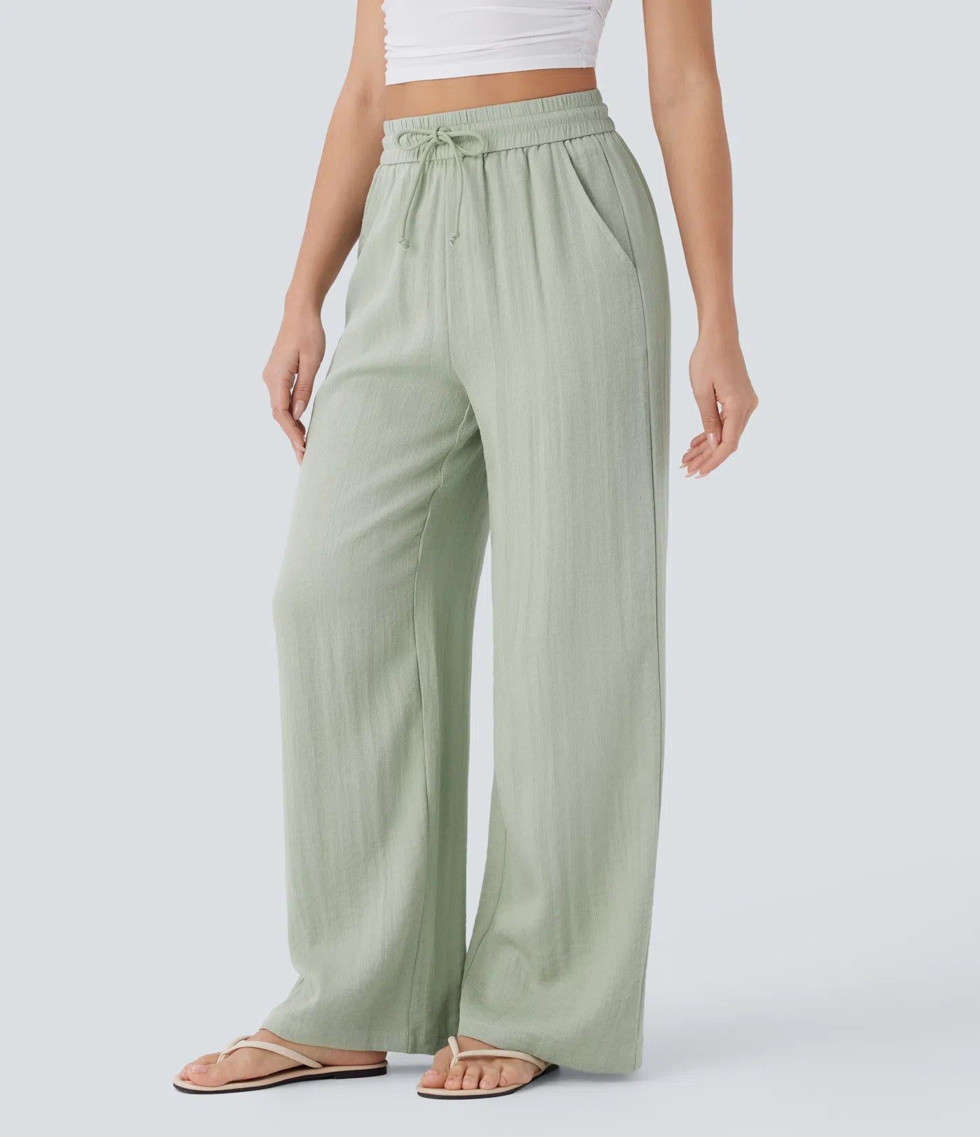 Casual pants with a linen-like feel, high waist, side drawstring, and wide-leg cut.